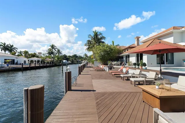 a view of a patio with furniture and a lake view