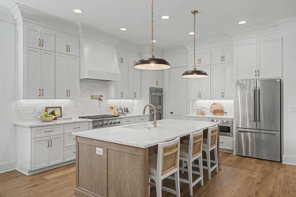 a view of a dining room with furniture a chandelier and wooden floor