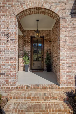 a view of a dining room with furniture a rug and wooden floor