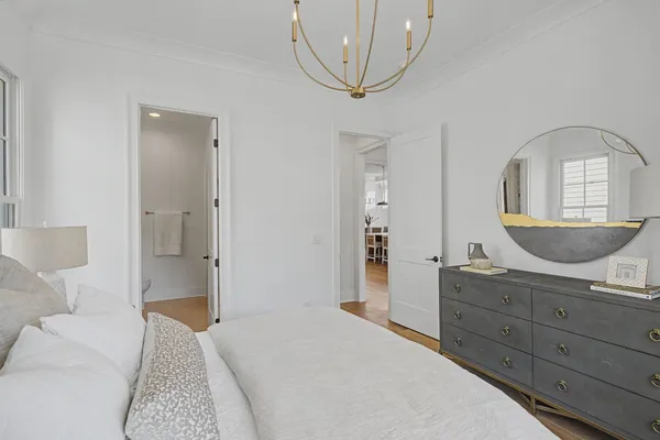 a view of a dining room and livingroom with furniture wooden floor a chandelier