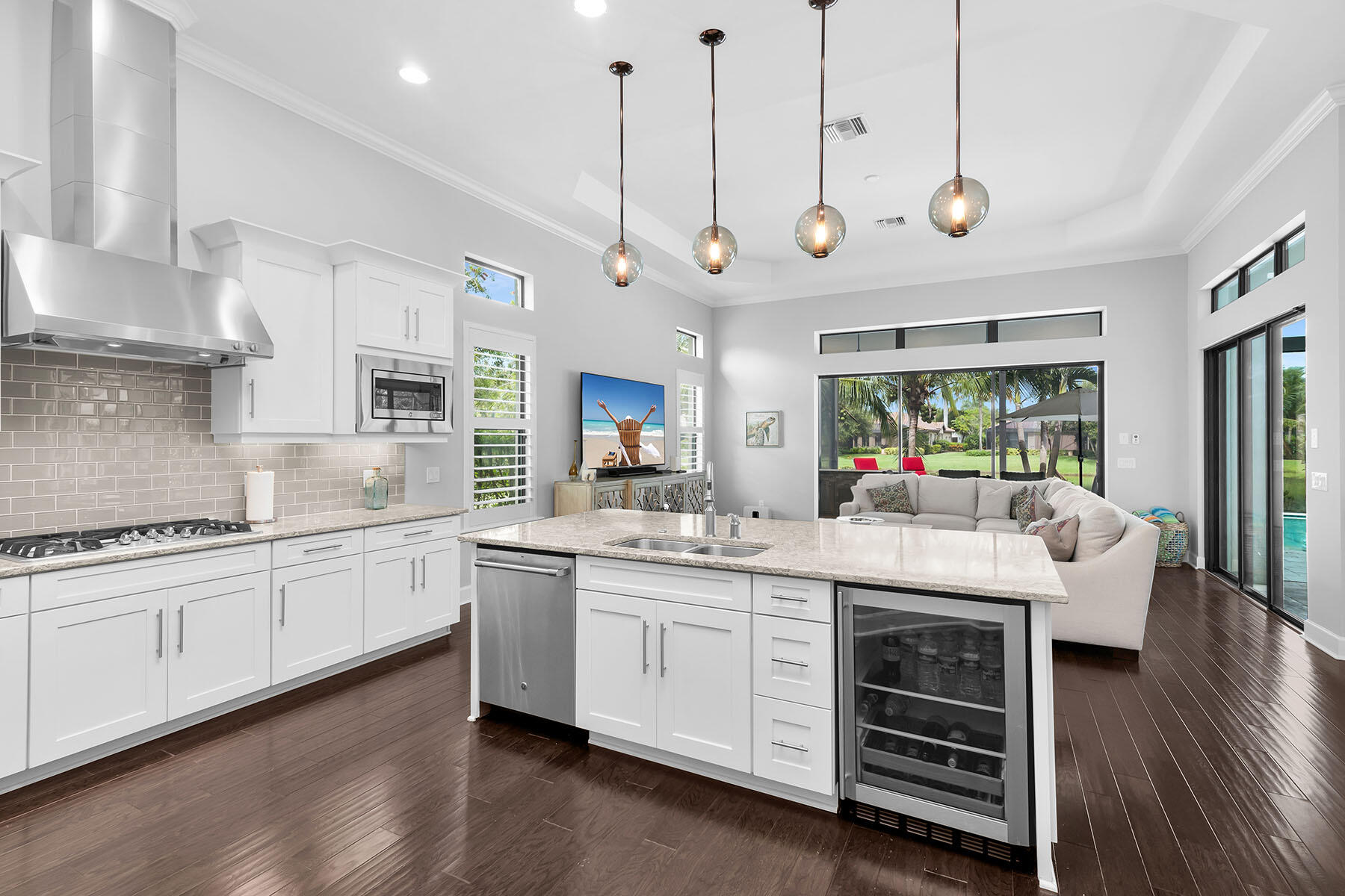 3193 Olympia Lane Naples, FL 34114 - Photo 11 of 50 a large kitchen with a lot of counter space and a wooden floor