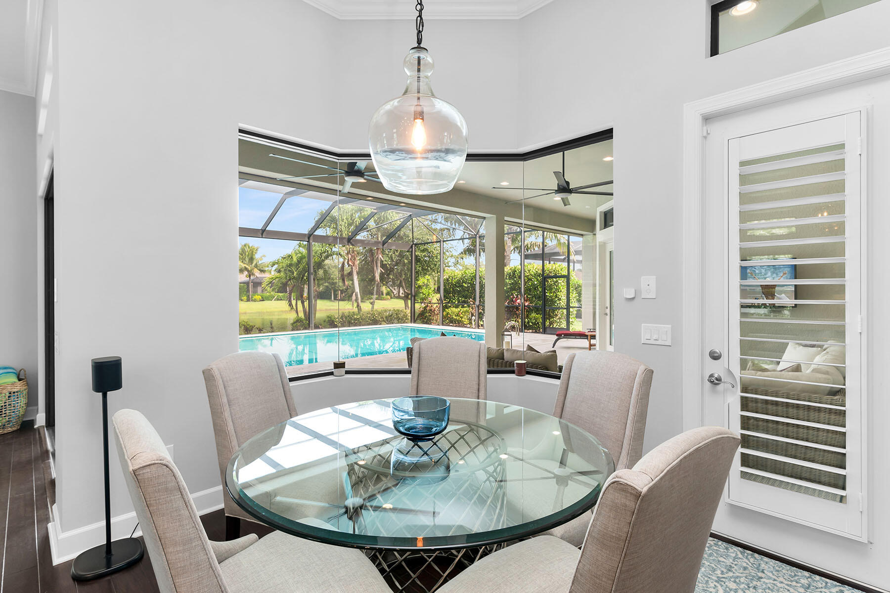 3193 Olympia Lane Naples, FL 34114 - Photo 13 of 50 a dining room with furniture a large window and wooden floor