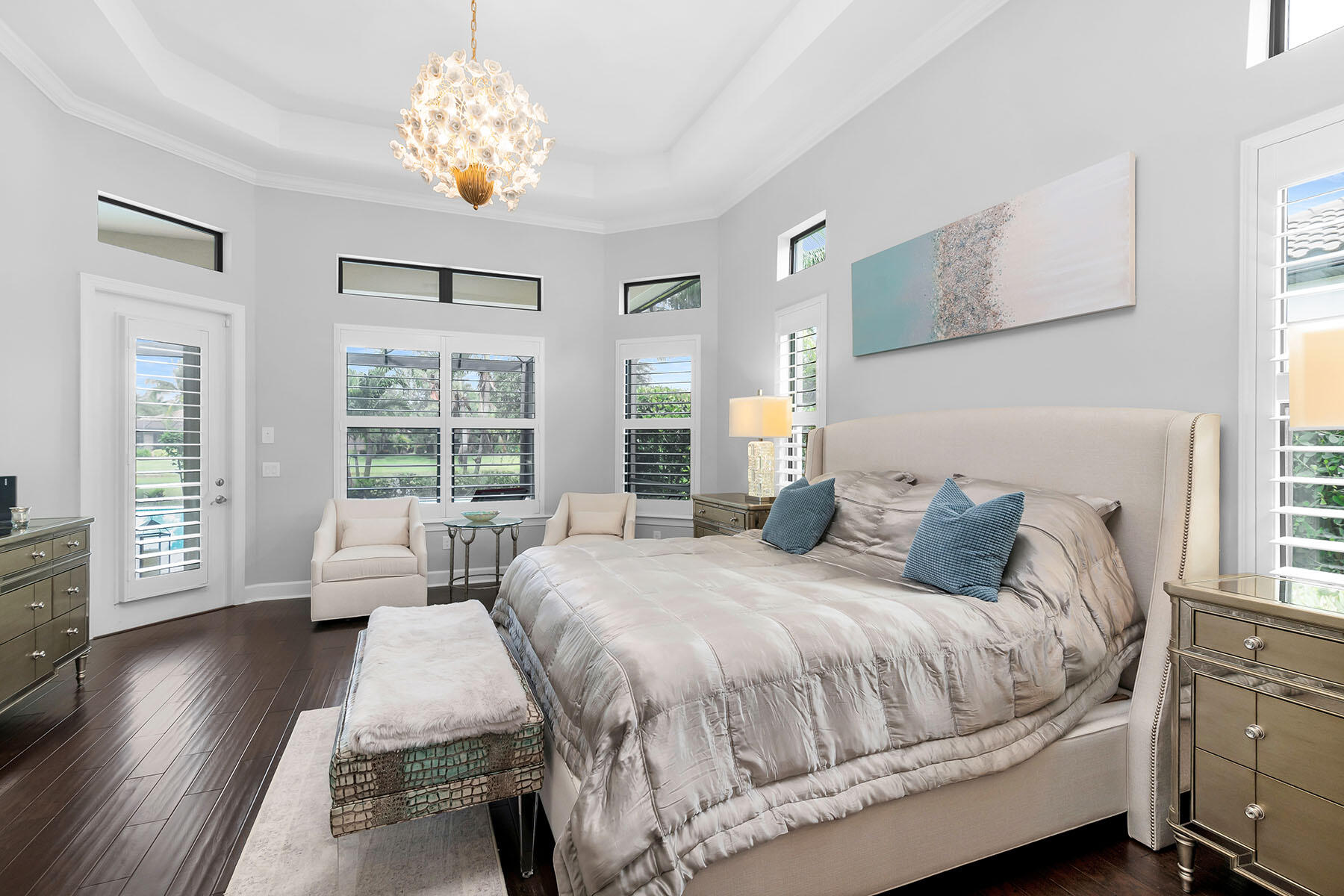 3193 Olympia Lane Naples, FL 34114 - Photo 16 of 50 a bedroom with a large bed and a chandelier