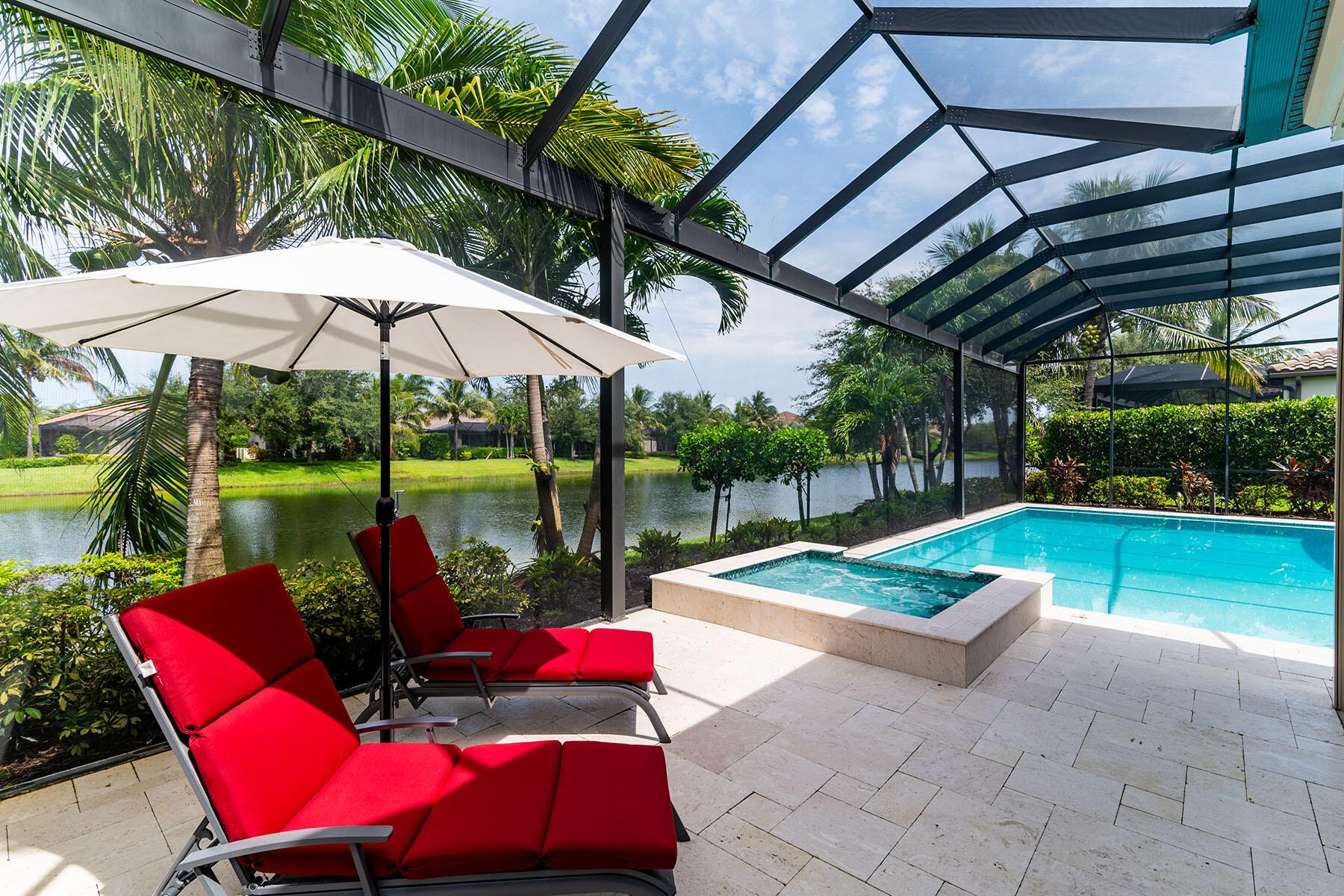3193 Olympia Lane Naples, FL 34114 - Photo 33 of 50 a view of a chairs and table under an umbrella in backyard