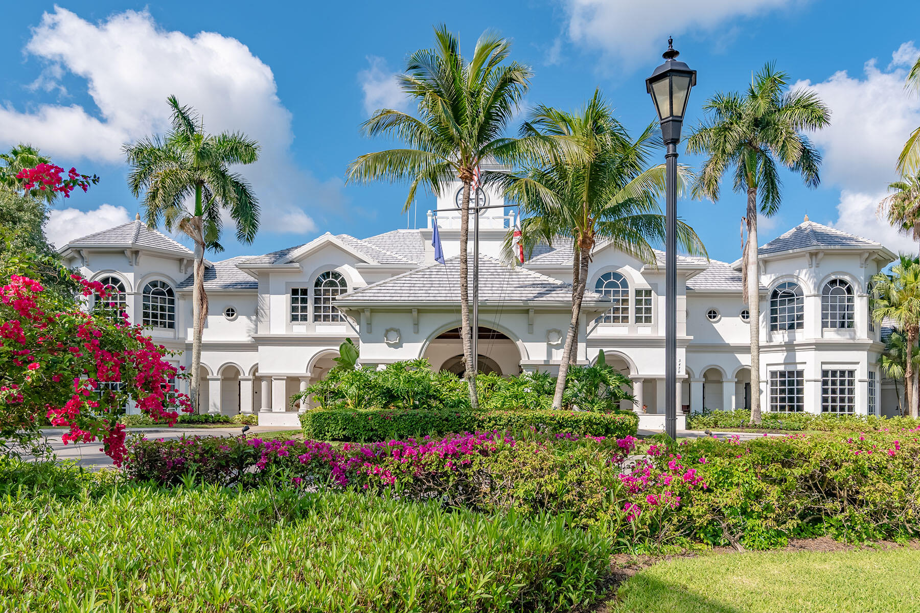 3193 Olympia Lane Naples, FL 34114 - Photo 43 of 50 a view of a white house with a yard and potted plants