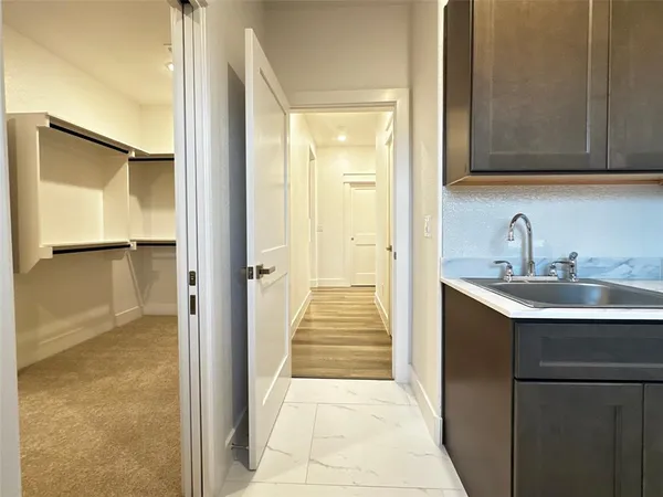 a large kitchen with stainless steel appliances a large counter top a stove and a refrigerator