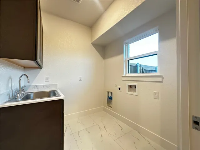 a view of kitchen with kitchen island granite countertop wooden cabinets and sink