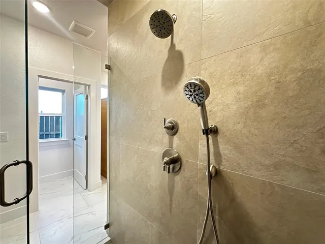 a bathroom with a shower and a sink