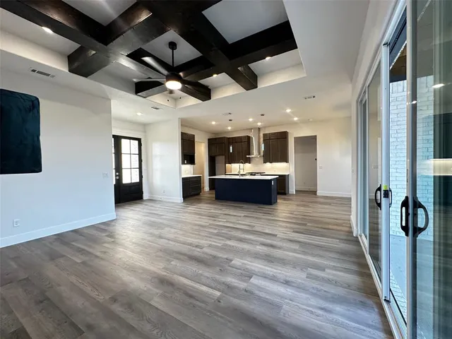 a kitchen with granite countertop a stove and a wooden floors