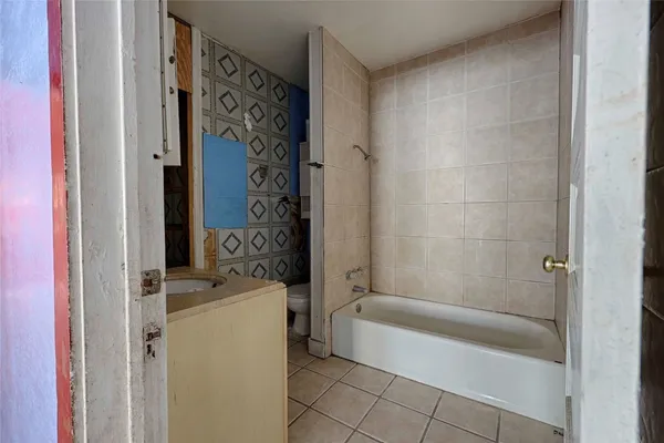 a bathroom with a bathtub and shower
