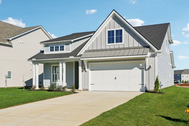 a front view of a house with a yard and garage