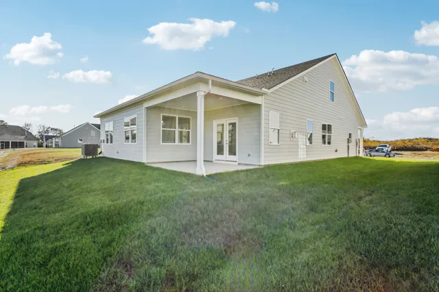 a view of an house with backyard porch and garden