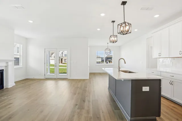 a view of kitchen and center island in wooden floor