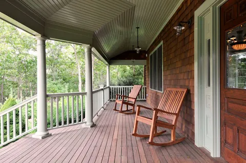 a view of a two chairs with wooden floor and outdoor seating