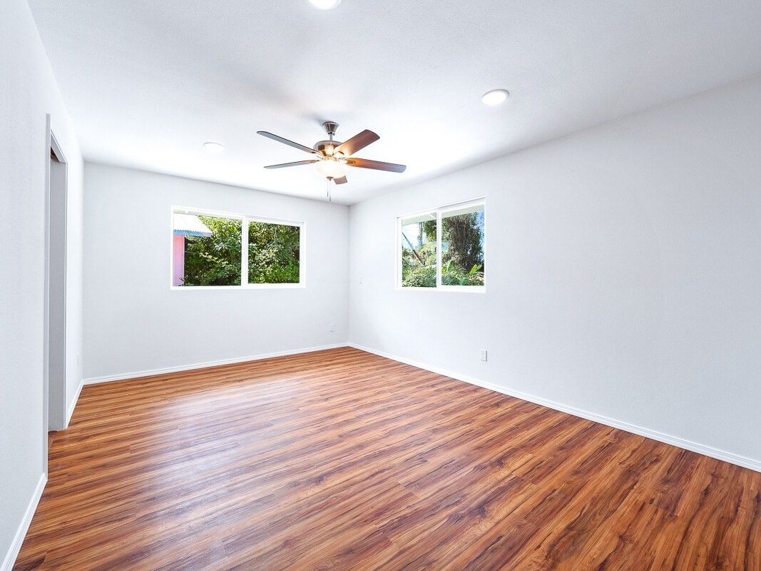 Peleke Road Mountain View, HI 96771 - Photo 13 of 24 a view of an empty room with wooden floor and a window