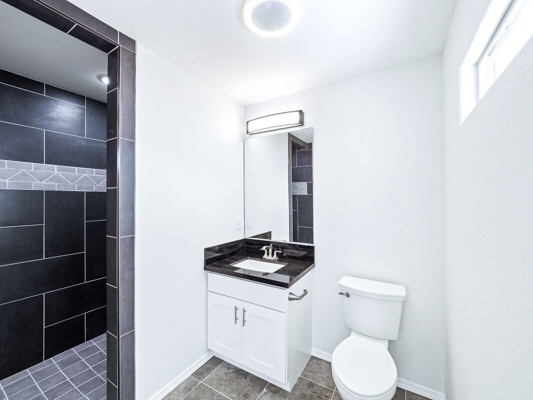 Peleke Road Mountain View, HI 96771 - Photo 16 of 24 a bathroom with a toilet a sink and mirror