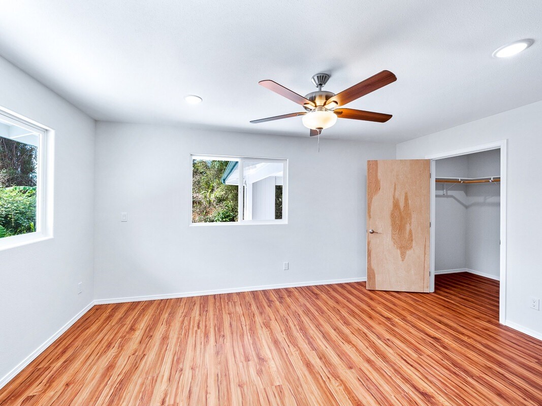 Peleke Road Mountain View, HI 96771 - Photo 19 of 24 a view of a room with wooden floor and a ceiling fan
