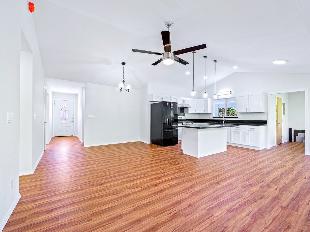 Peleke Road Mountain View, HI 96771 - Photo 3 of 24 a view of kitchen with refrigerator and wooden floor
