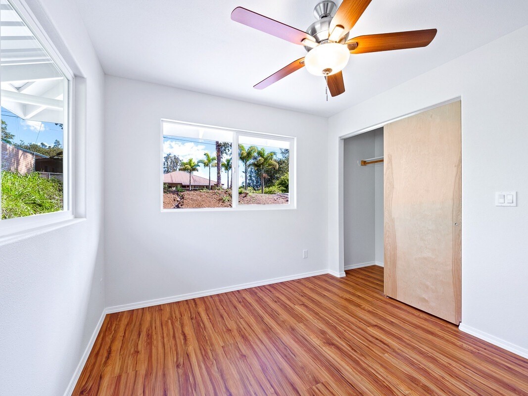 Peleke Road Mountain View, HI 96771 - Photo 9 of 24 a view of empty room with wooden floor and fan
