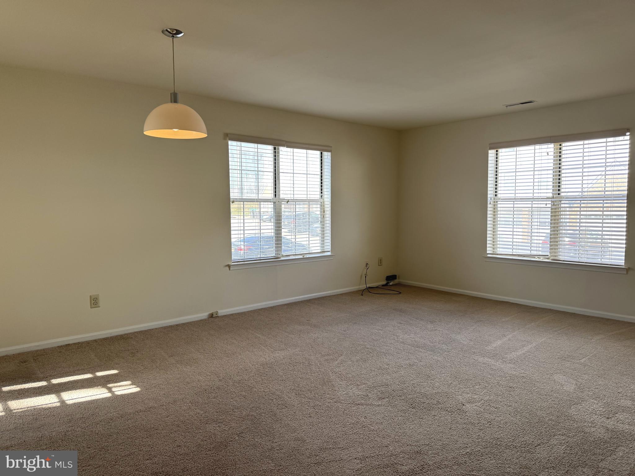 131 Chadd Road, Unit A Newark, DE 19711 - Photo 2 of 8 an empty room with a windows and chandelier