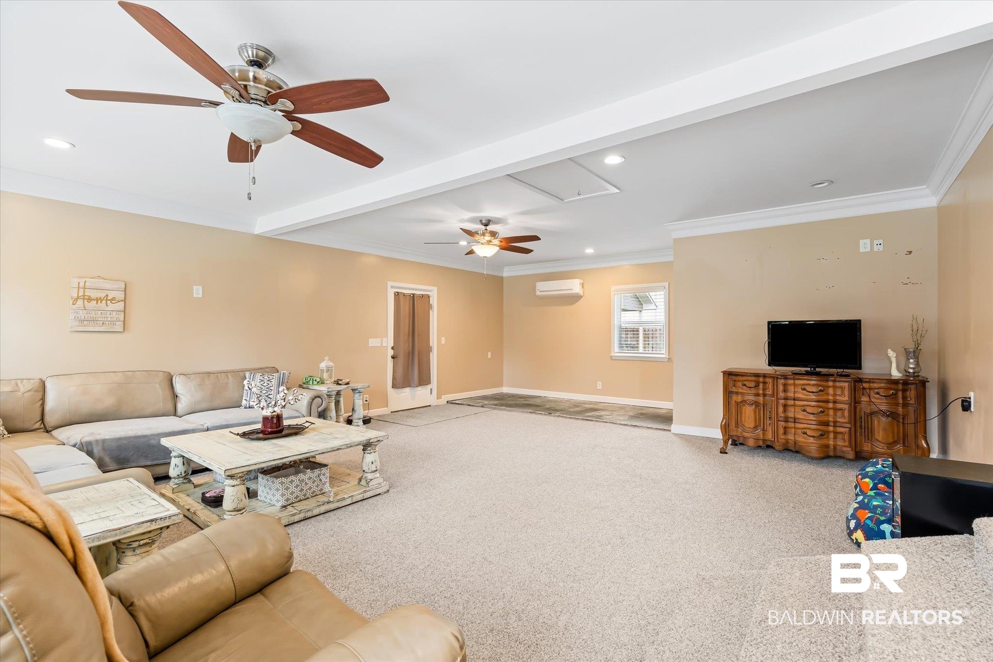 10391 County Road 64 Daphne, AL 36526 - Photo 8 of 23 Carpeted living room with beam ceiling, crown molding, an AC wall unit, and ceiling fan