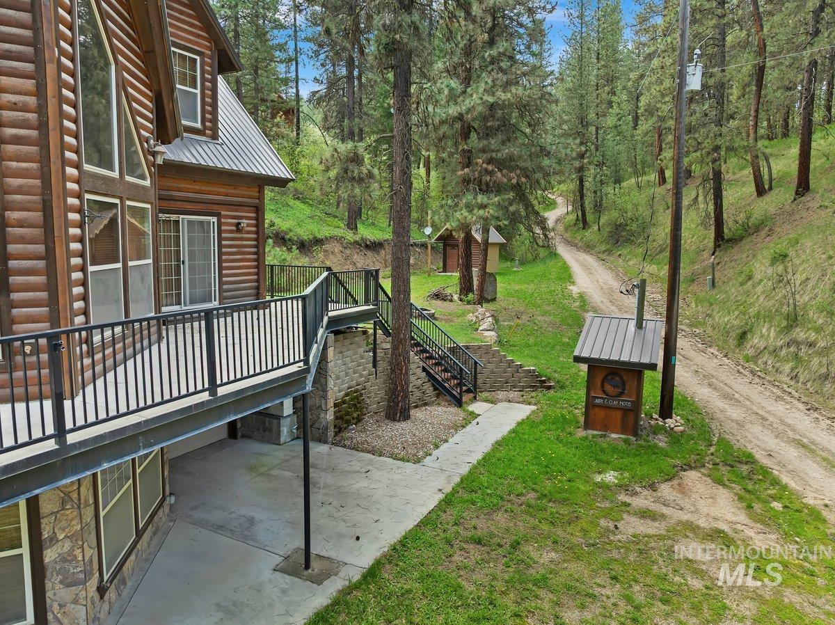 11 Forest Trail Road Garden Valley, ID 83622 - Photo 31 of 42 View of yard featuring stairway, a patio area, an outdoor structure, and a balcony
