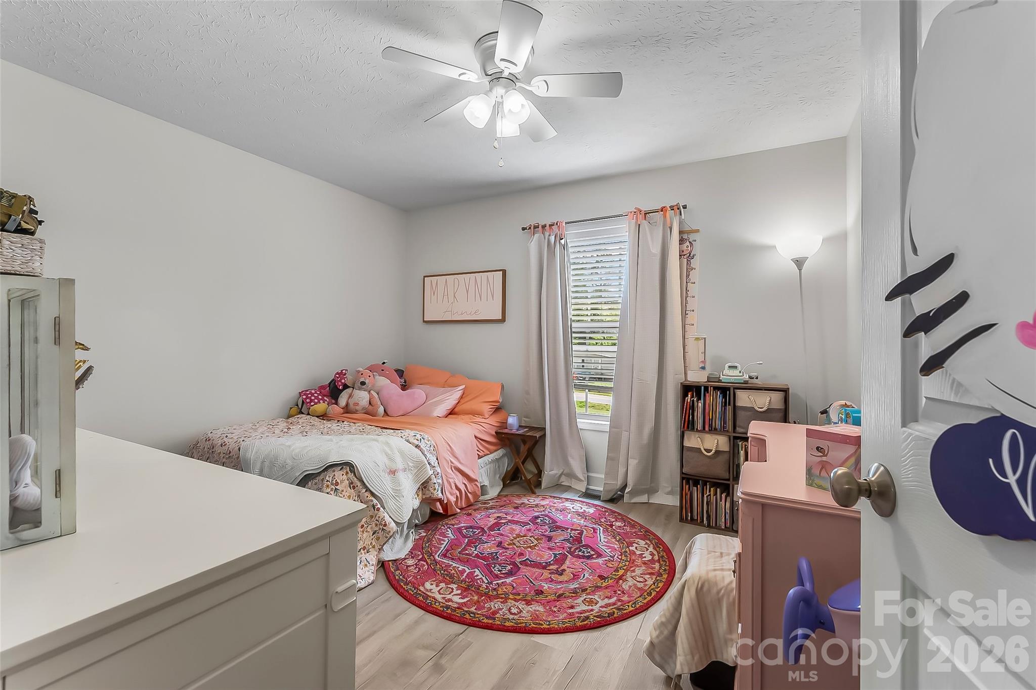 1498 Salem Road Morganton, NC 28655 - Photo 20 of 32 a bedroom with a bed and a chandelier