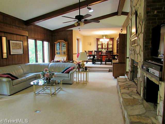 604 Ragsdale Road Jamestown, NC 27282 - Photo 2 of 16 Living Room. Vaulted, beamed ceiling soars over the spacious living room. Stone fireplace warms the space.