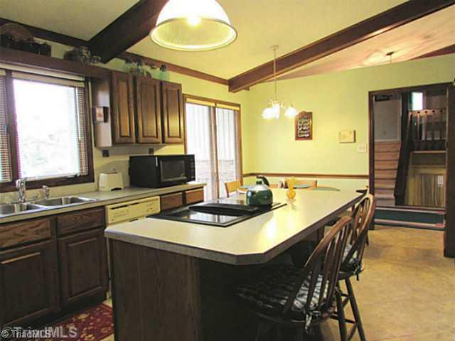 604 Ragsdale Road Jamestown, NC 27282 - Photo 4 of 16 Kitchen. The sunny kitchen offers an island and Jenn-Air range, plus vaulted ceiling & skylight.