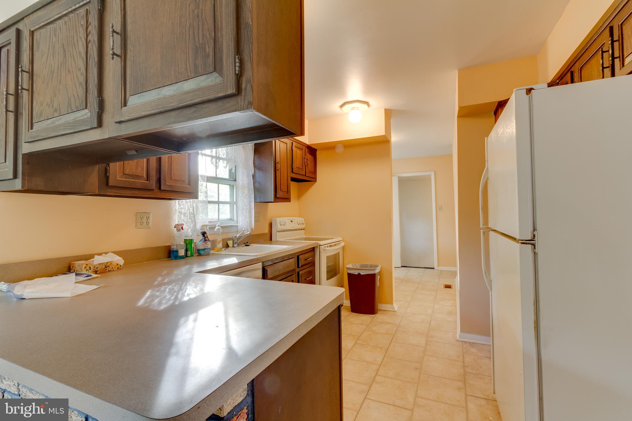 225 Sunnybrook Road Barrington, NJ 08007 - Photo 19 of 26 a kitchen with stainless steel appliances granite countertop a sink and a refrigerator