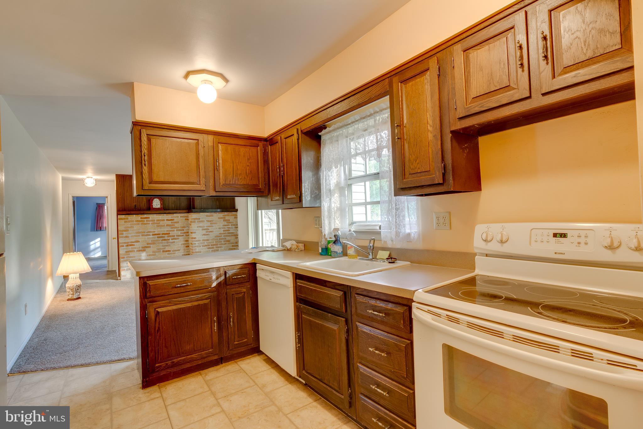 225 Sunnybrook Road Barrington, NJ 08007 - Photo 20 of 26 a kitchen with a sink stove and cabinets