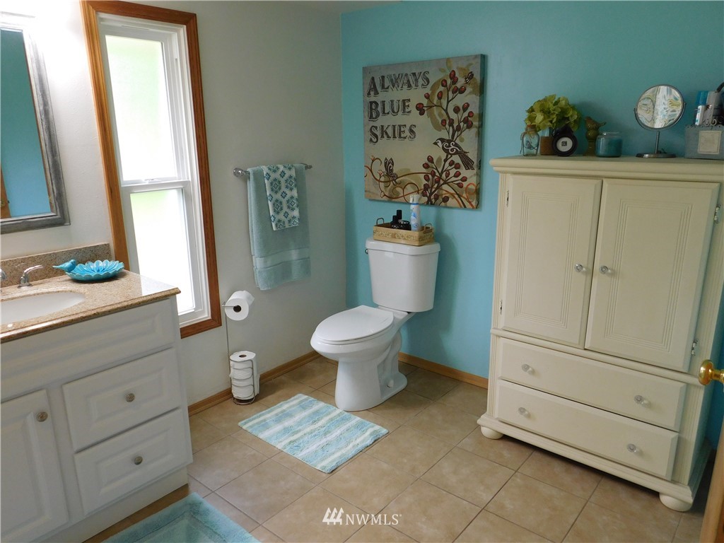 2902 Jackson Highway Chehalis, WA 98532 - Photo 16 of 32 a bathroom with a toilet sink and mirror