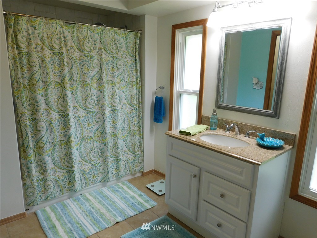 2902 Jackson Highway Chehalis, WA 98532 - Photo 17 of 32 a bathroom with a sink and a mirror