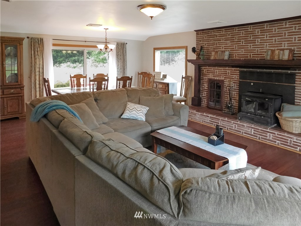 2902 Jackson Highway Chehalis, WA 98532 - Photo 5 of 32 a living room with furniture flat screen tv and a fireplace