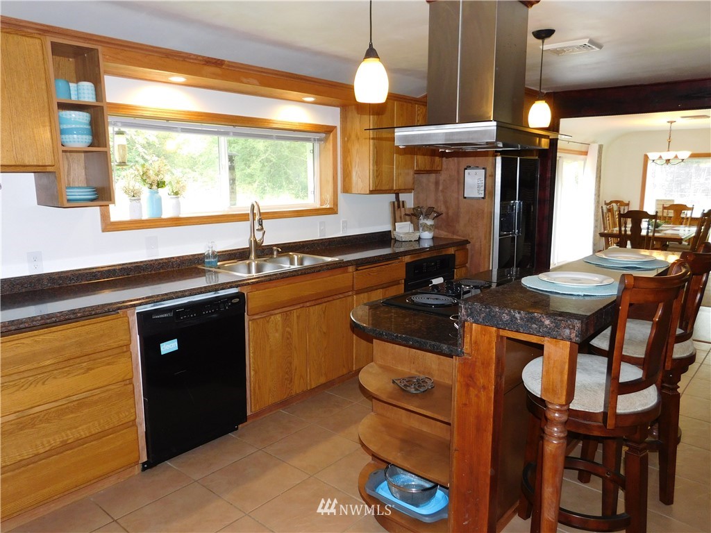 2902 Jackson Highway Chehalis, WA 98532 - Photo 10 of 32 a kitchen with stainless steel appliances granite countertop a sink a stove and a refrigerator