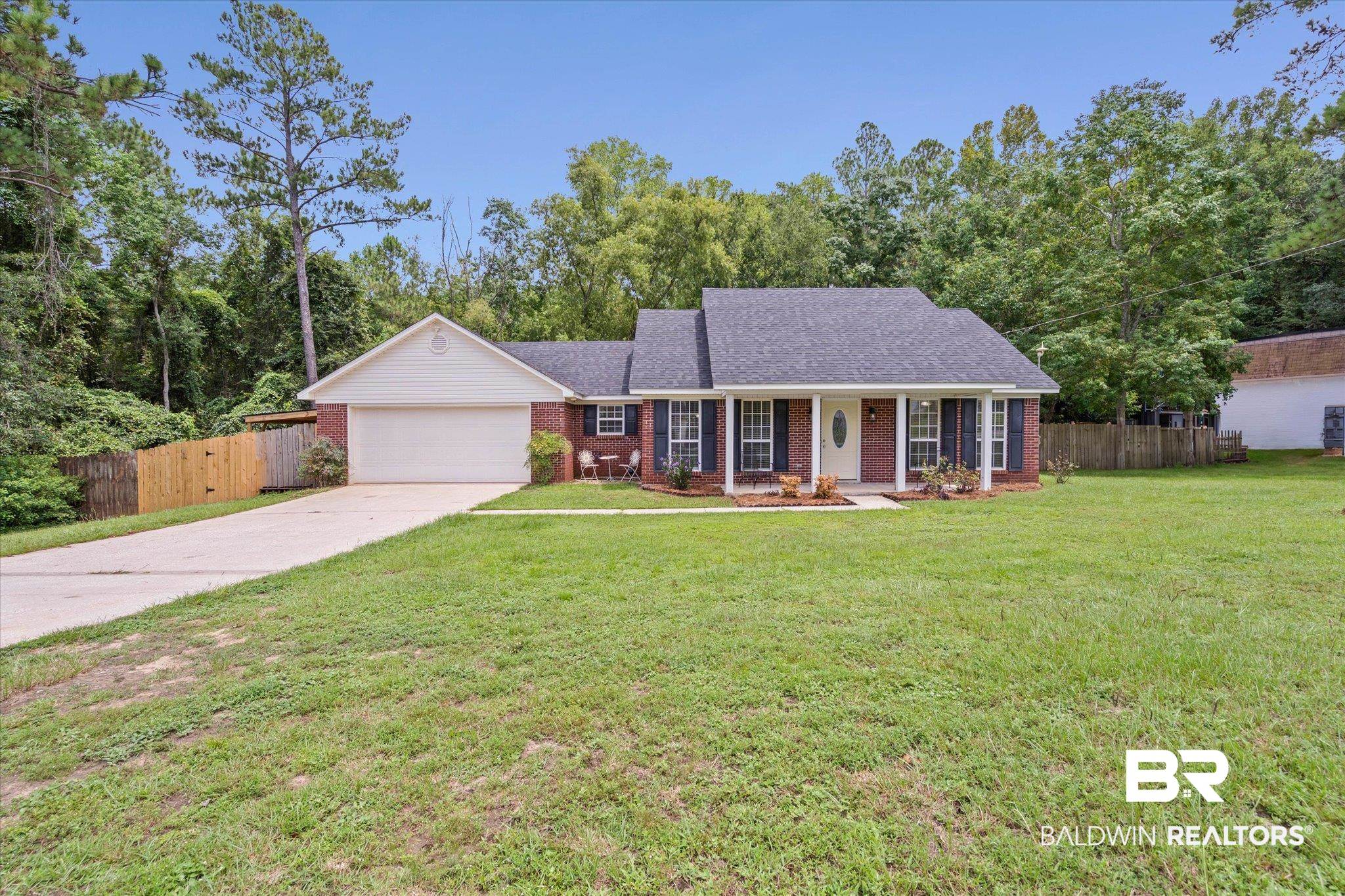 157 Bay View Drive Daphne, AL 36526 - Photo 20 of 22 Ranch-style home featuring brick siding, a porch, driveway, and an attached garage