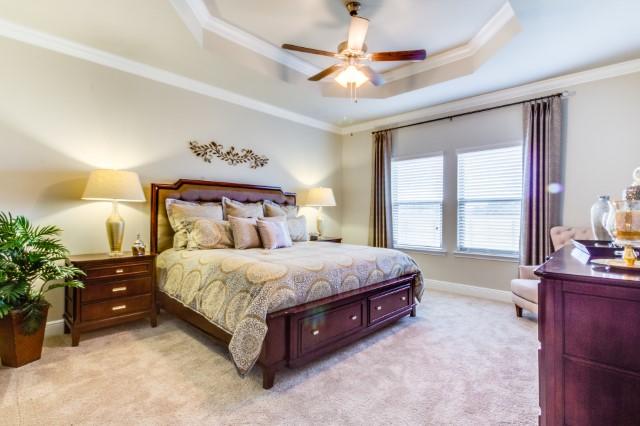 127 Hobson Avenue Crestview, FL 32539 - Photo 7 of 21 a spacious bedroom with a bed and a chandelier