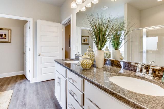 127 Hobson Avenue Crestview, FL 32539 - Photo 9 of 21 a bathroom with a granite countertop sink a mirror and a shower