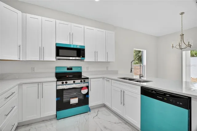 a kitchen with white cabinets and appliances