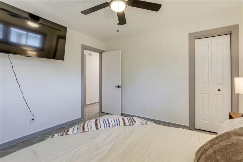 1944 Cindy Drive Decatur, GA 30032 - Photo 16 of 22 a bedroom with a bed and a chandelier