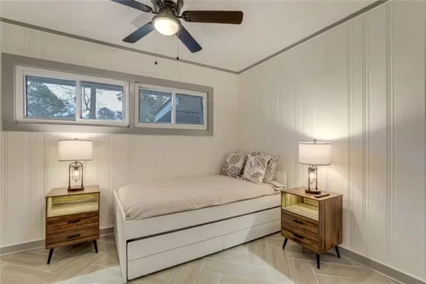 a bedroom with a bed and a chandelier