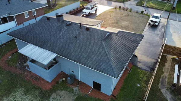 an aerial view of a house with a yard