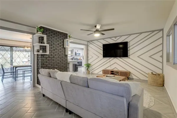 a living room with furniture fireplace and flat screen tv