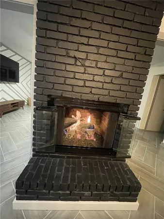 a view of fireplace with wooden floor