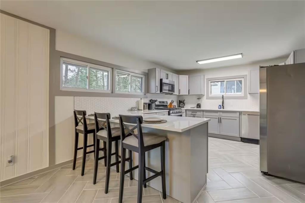 1944 Cindy Drive Decatur, GA 30032 - Photo 9 of 22 a kitchen with white cabinets and chairs