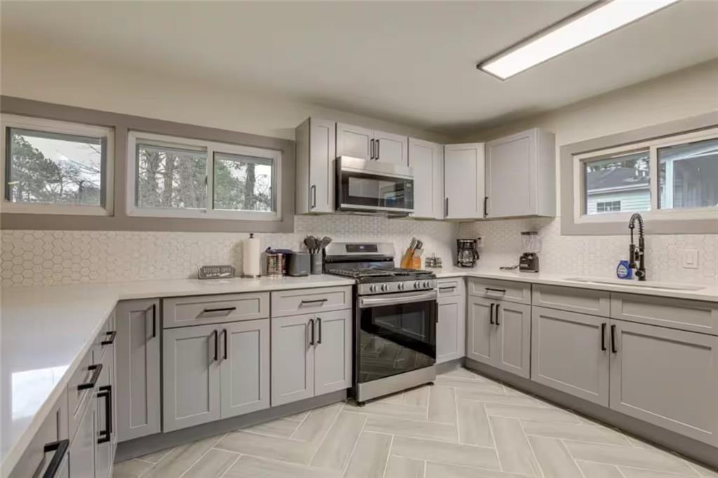 1944 Cindy Drive Decatur, GA 30032 - Photo 10 of 22 a kitchen with cabinets appliances a sink and a window