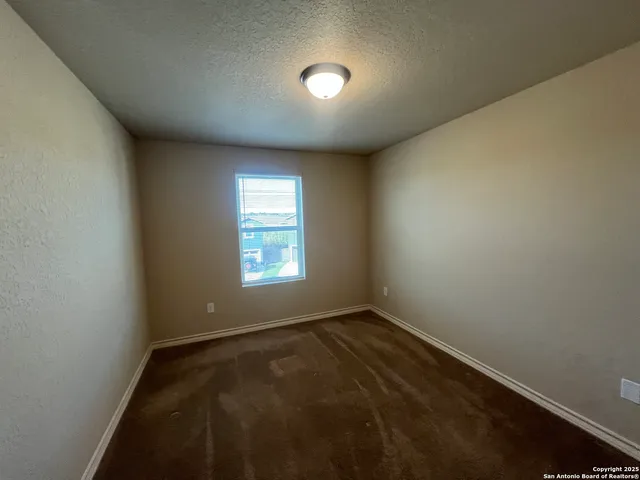 an empty room with a empty space and windows