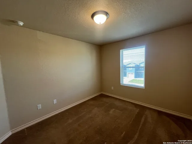 an empty room with a empty space and windows