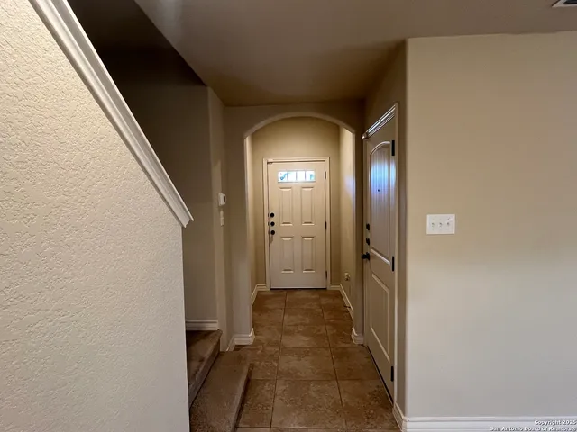 a view of a hallway with wooden floor and a hallway