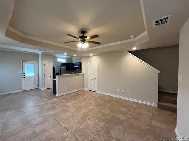 a view of a livingroom with a ceiling fan and window
